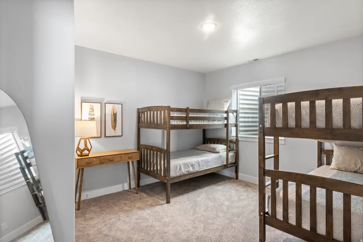 Bedroom with light carpet and baseboards