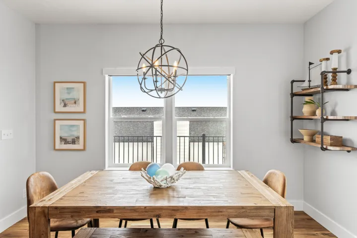Dining room with wood finished floors and hanging lights