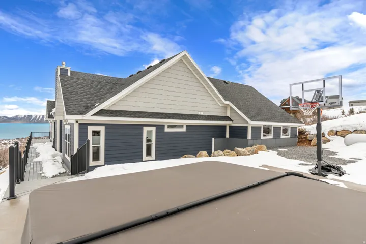 View of front of property with roof with shingles and a chimney