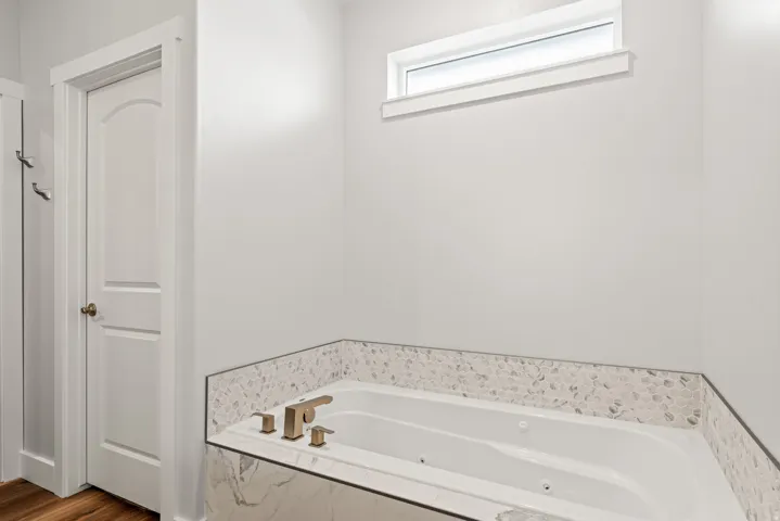 Full bathroom featuring a whirlpool tub