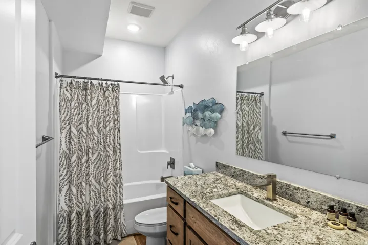Full bath with vanity, shower / bath combo, and recessed lighting