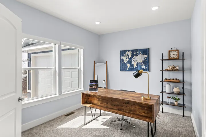 Home office with light carpet and recessed lighting