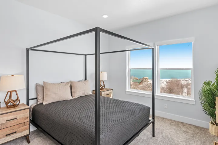 Bedroom with a water view and carpet floors