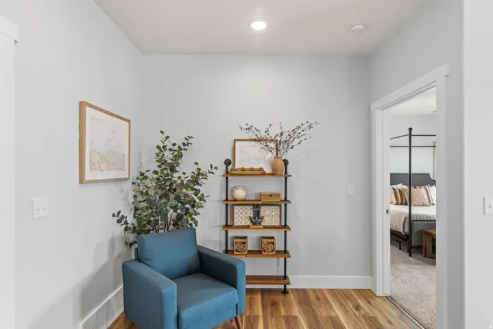 Sitting room with light wood-type flooring and baseboards