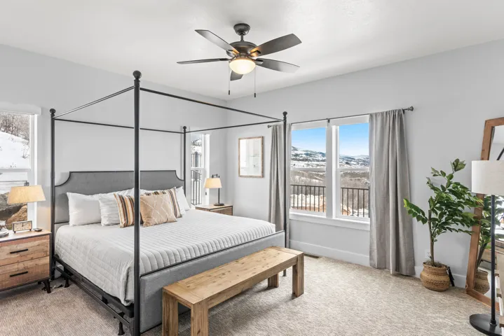 Bedroom featuring light colored carpet and a ceiling fan