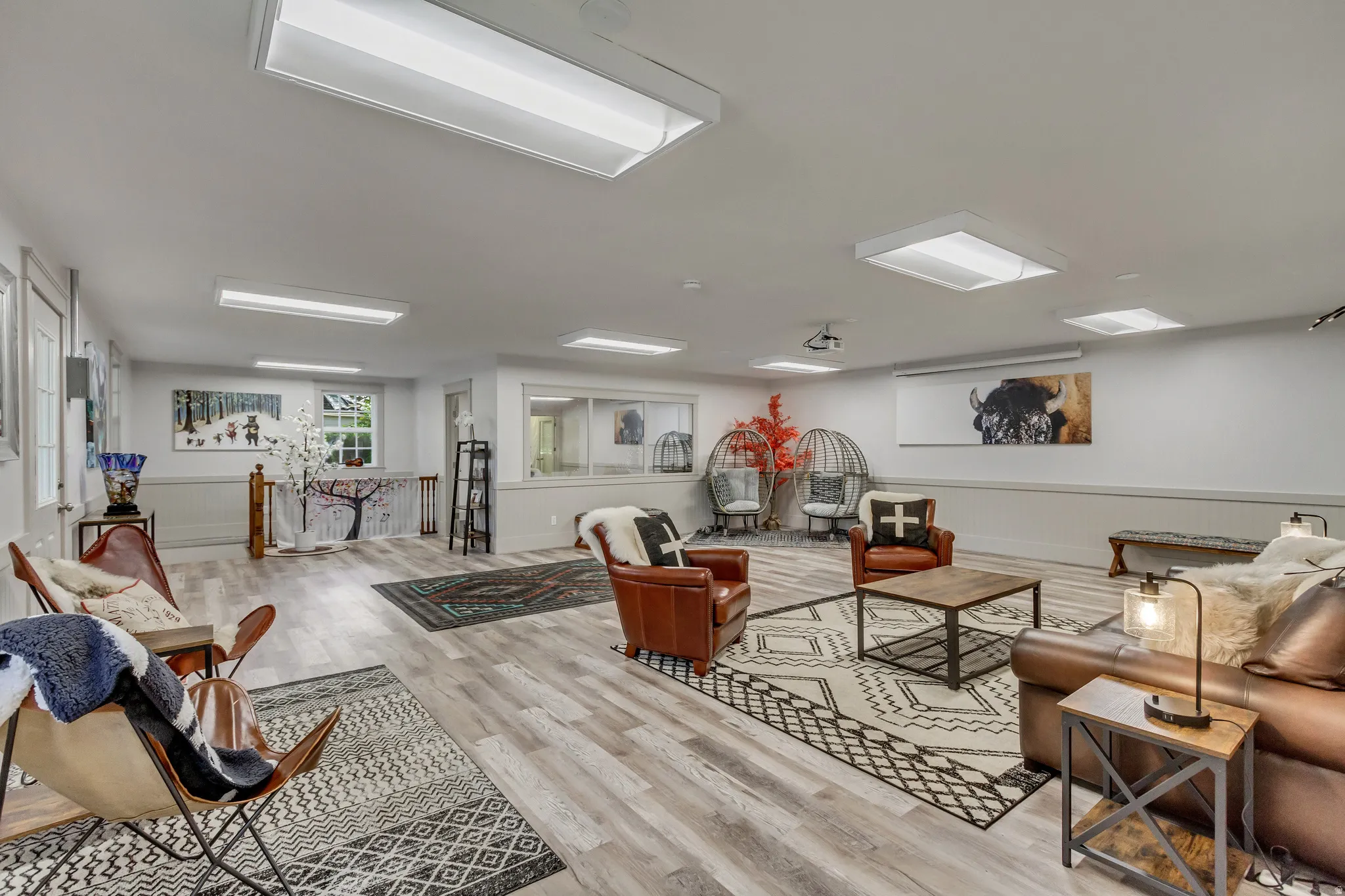 Living room with light wood finished floors and a wainscoted wall