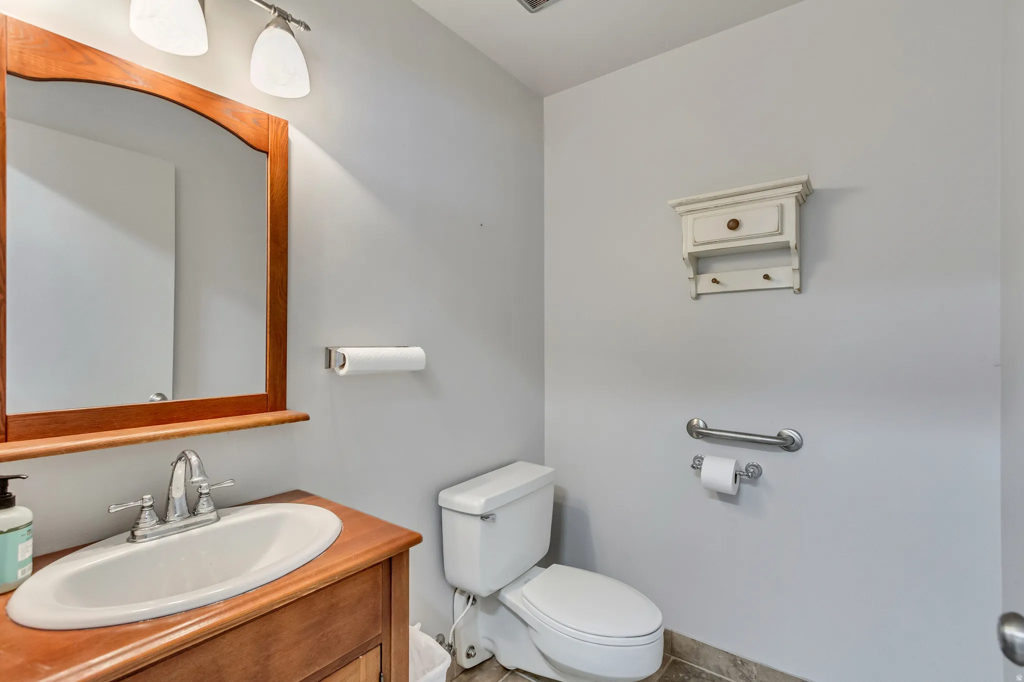 Half bath featuring vanity and toilet