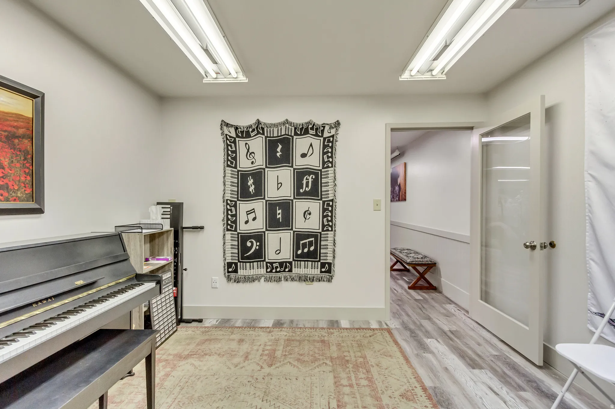 Miscellaneous room featuring light wood-style flooring and baseboards