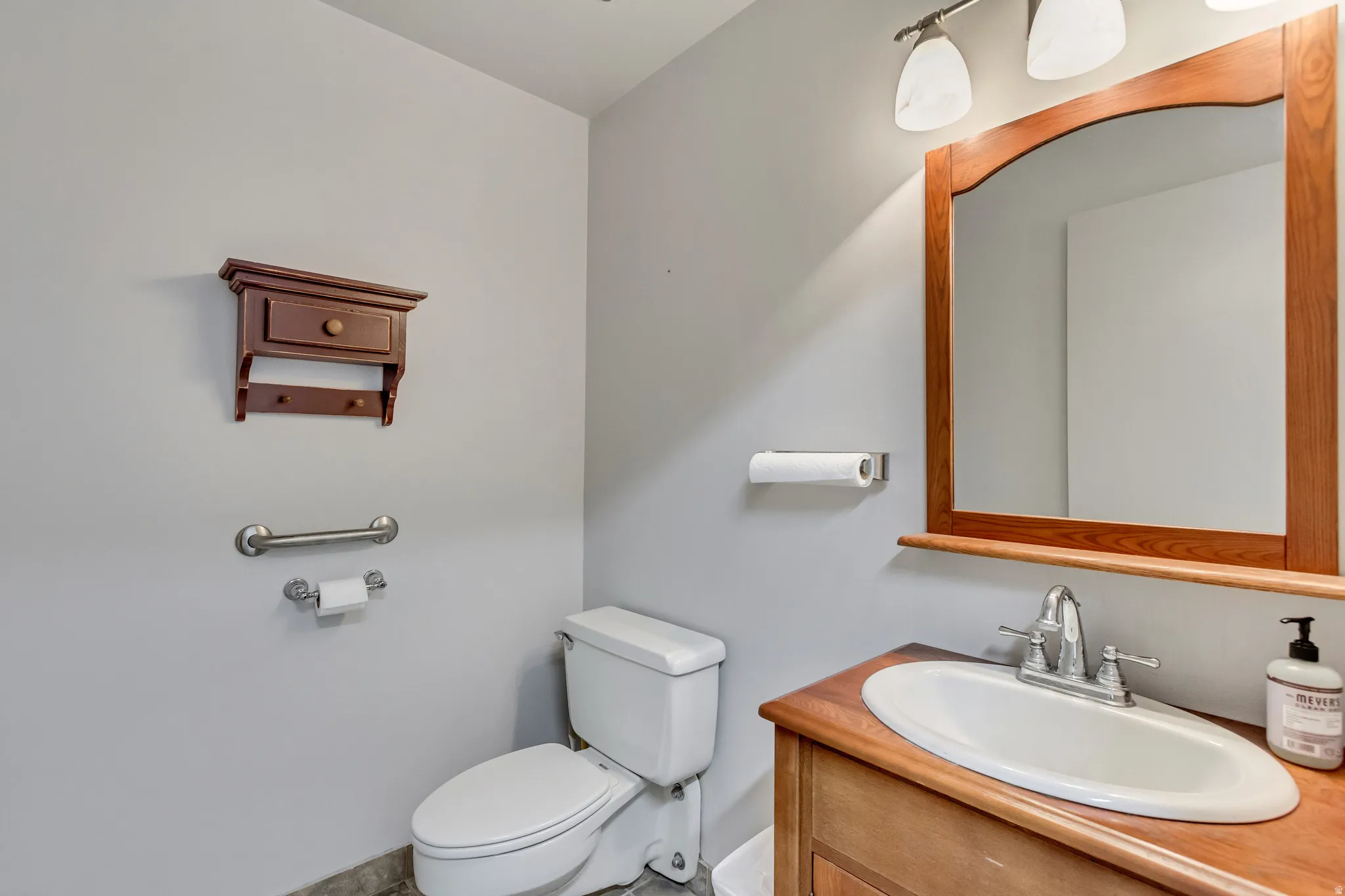 Half bath featuring vanity and toilet