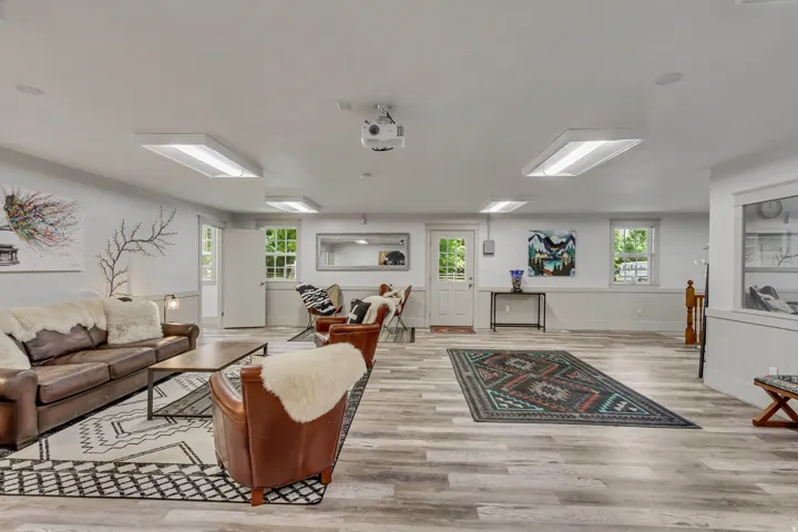 Living area featuring light wood-type flooring and baseboards