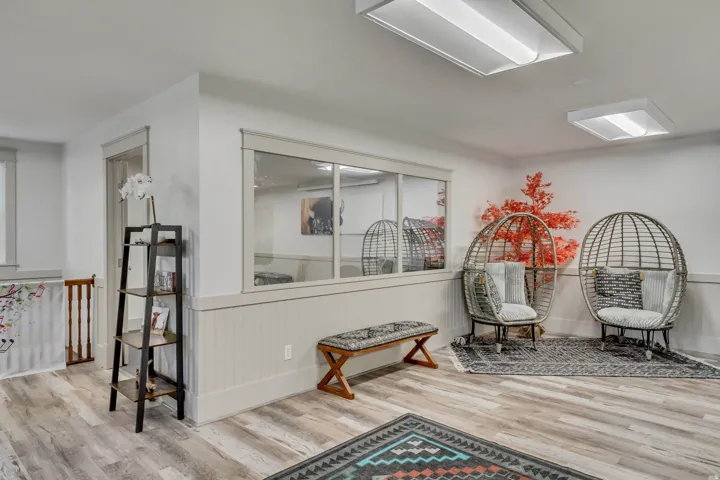 Living area with wainscoting and light wood-type flooring