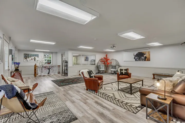Living room with light wood finished floors and a wainscoted wall