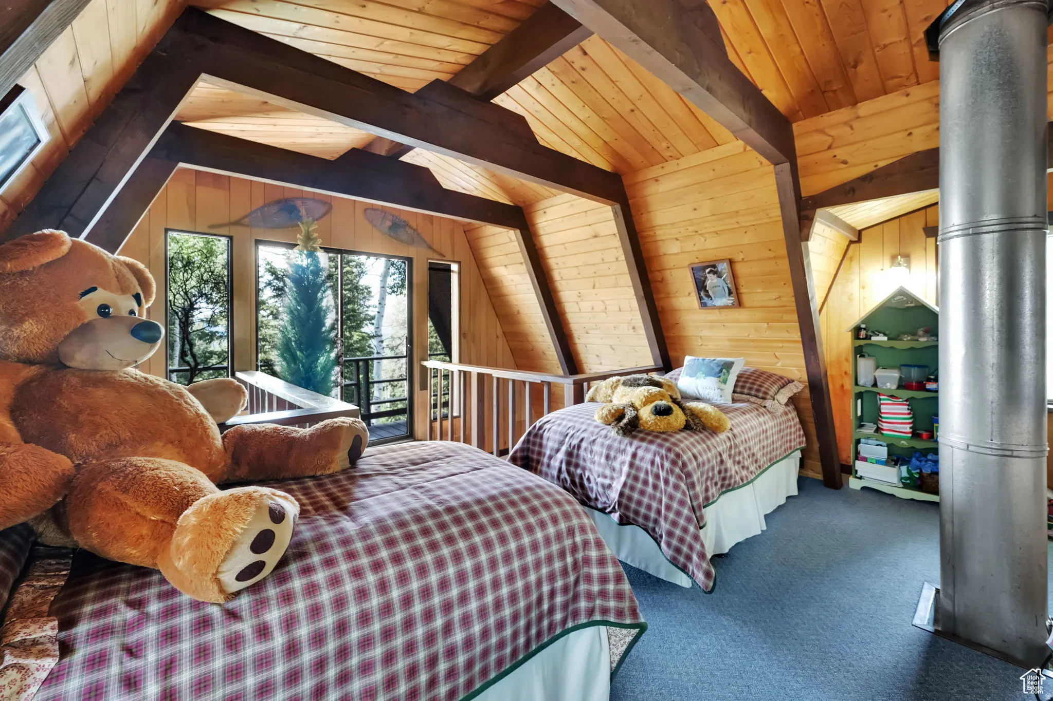 Carpeted bedroom featuring wood walls, a wood ceiling with exposed beams, and access to exterior