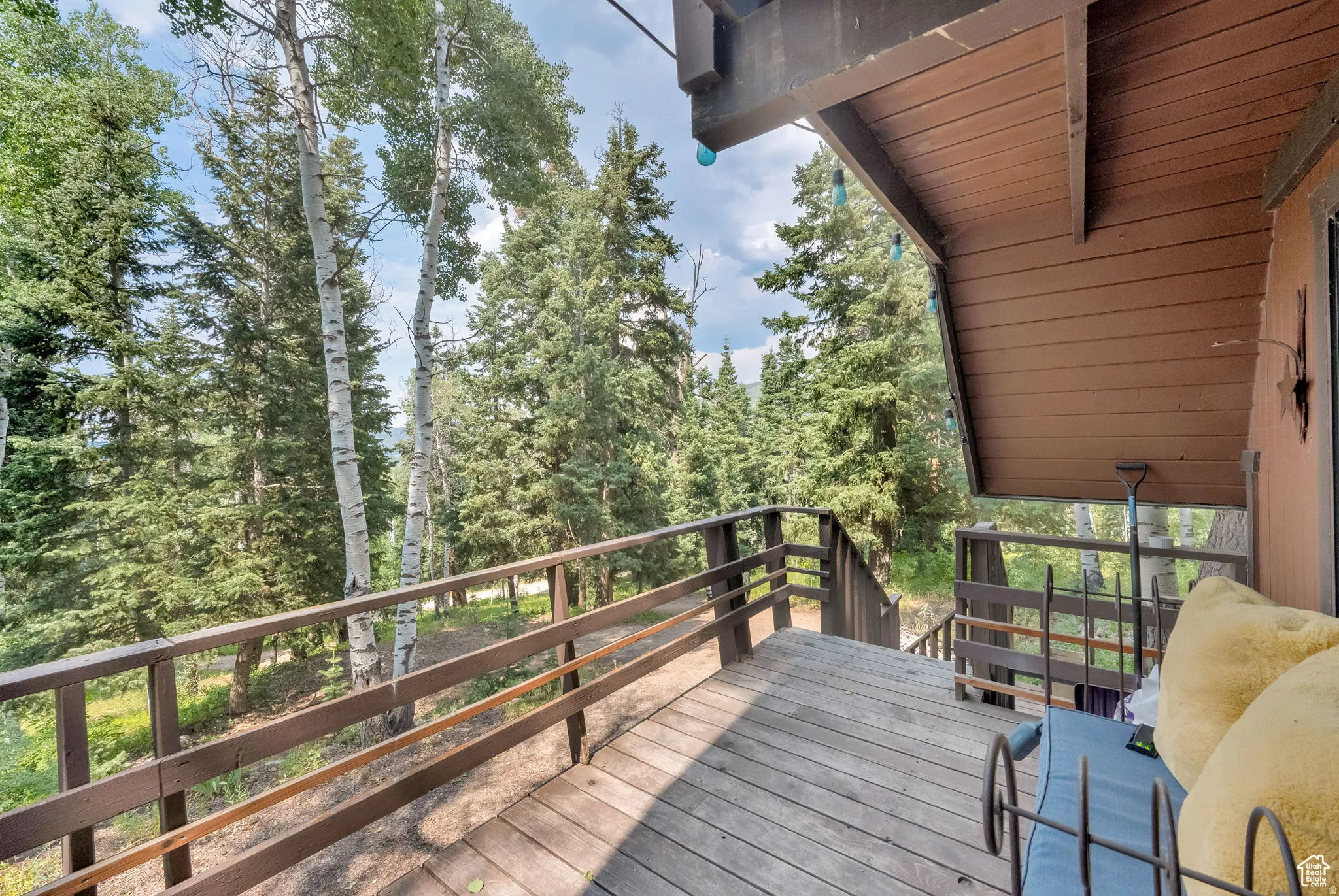 Wooden terrace featuring view of scattered trees