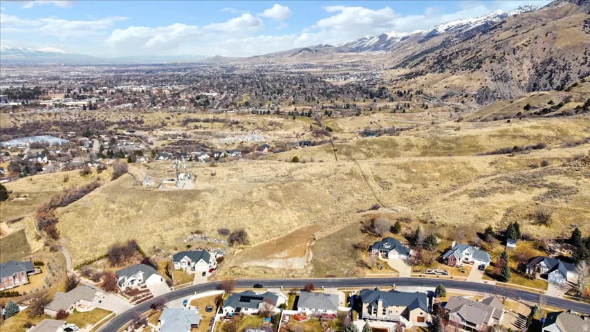 View of property location featuring nearby suburban area and a mountain backdrop
