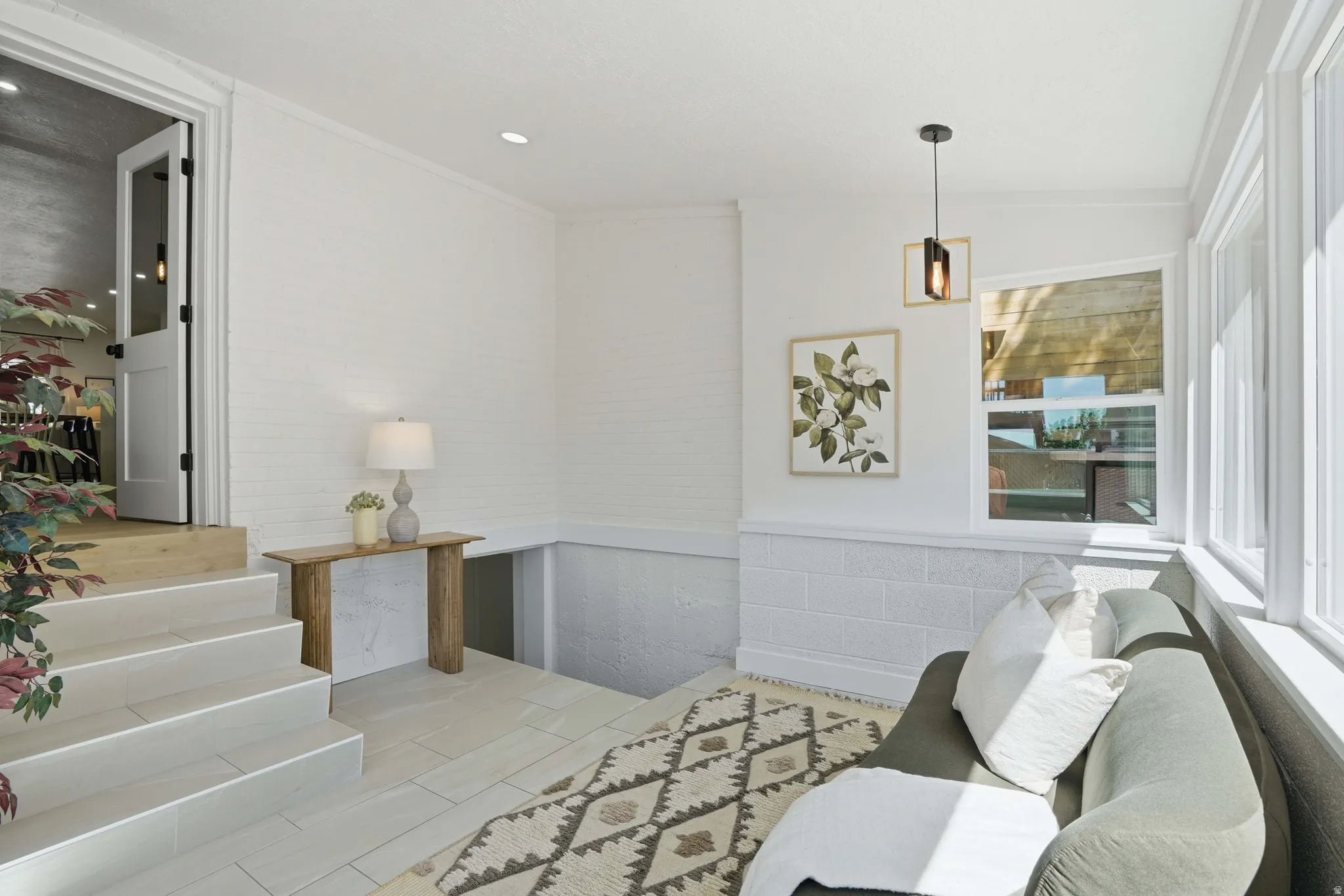 Sun room featuring a wainscoted wall and recessed lighting