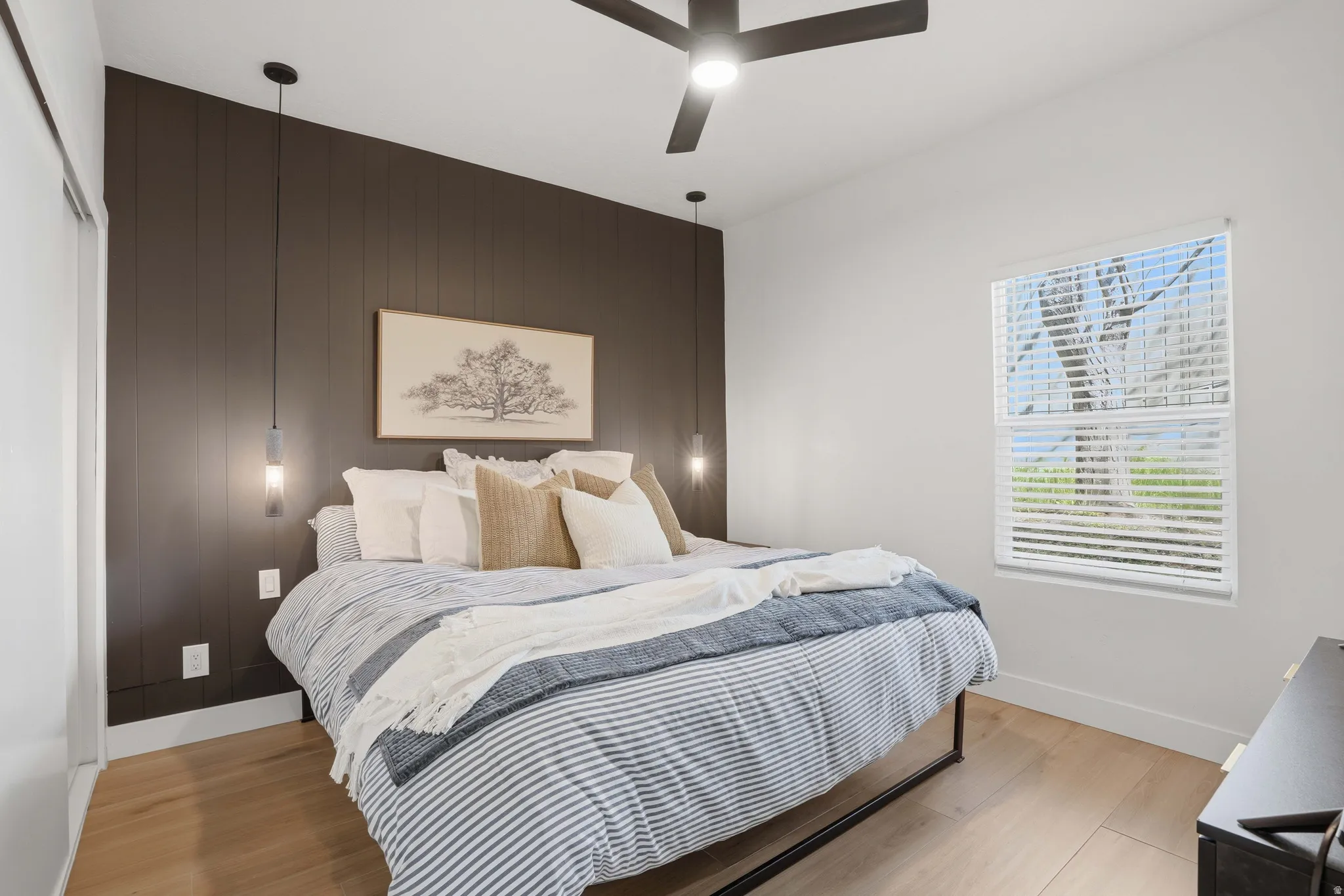 Bedroom featuring light wood-type finished floors, and ceiling fan