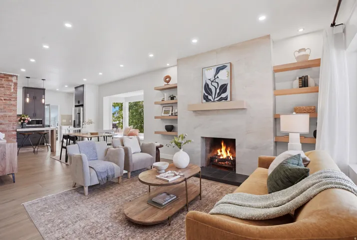 Living area with porcelain glazed tile flooring throughout, a fireplace, recessed lighting, and built in features