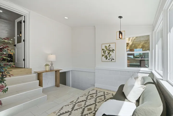 Sun room featuring a wainscoted wall and recessed lighting