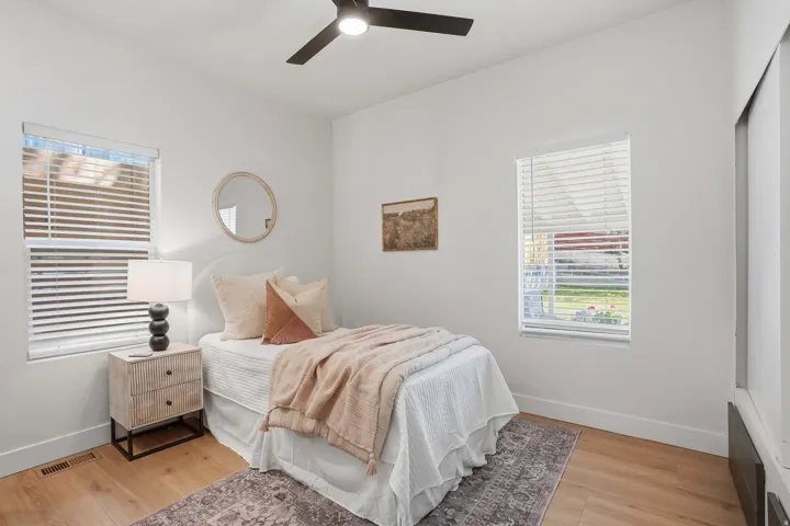 Bedroom featuring multiple windows, and ceiling fan