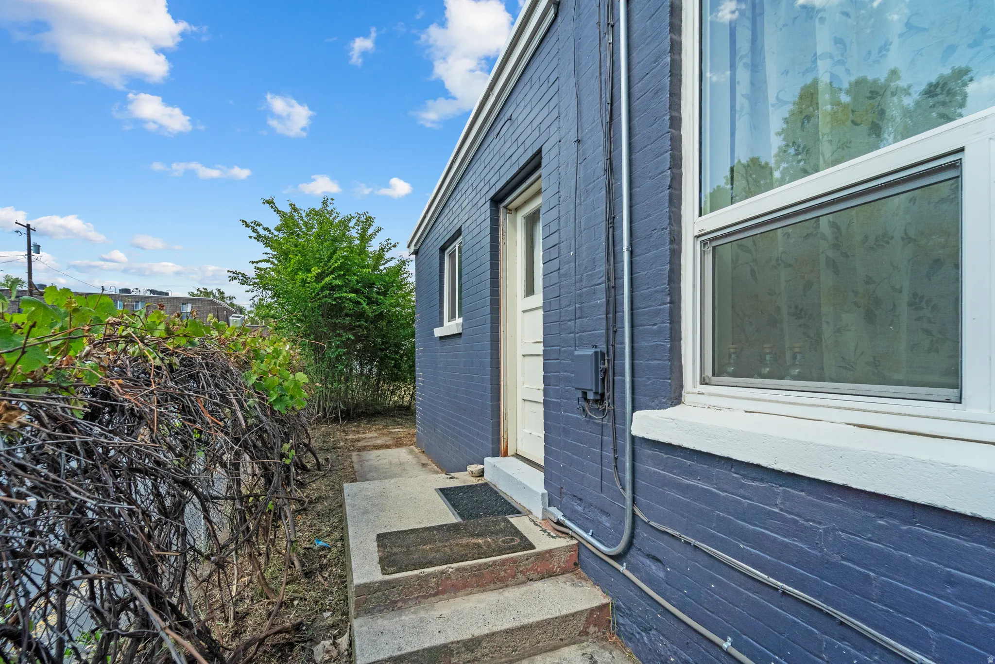 View of side of property with entry steps