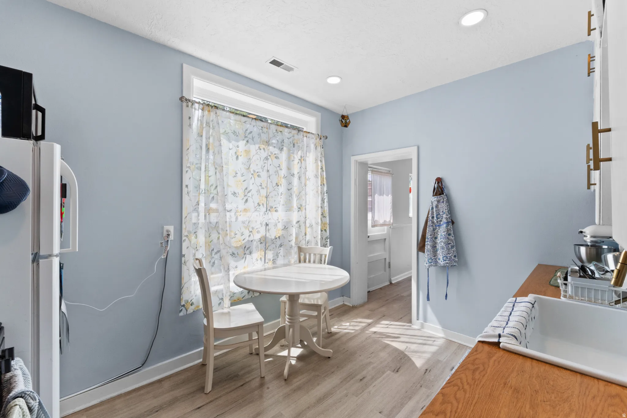 Dining area featuring light wood-type flooring and recessed lighting