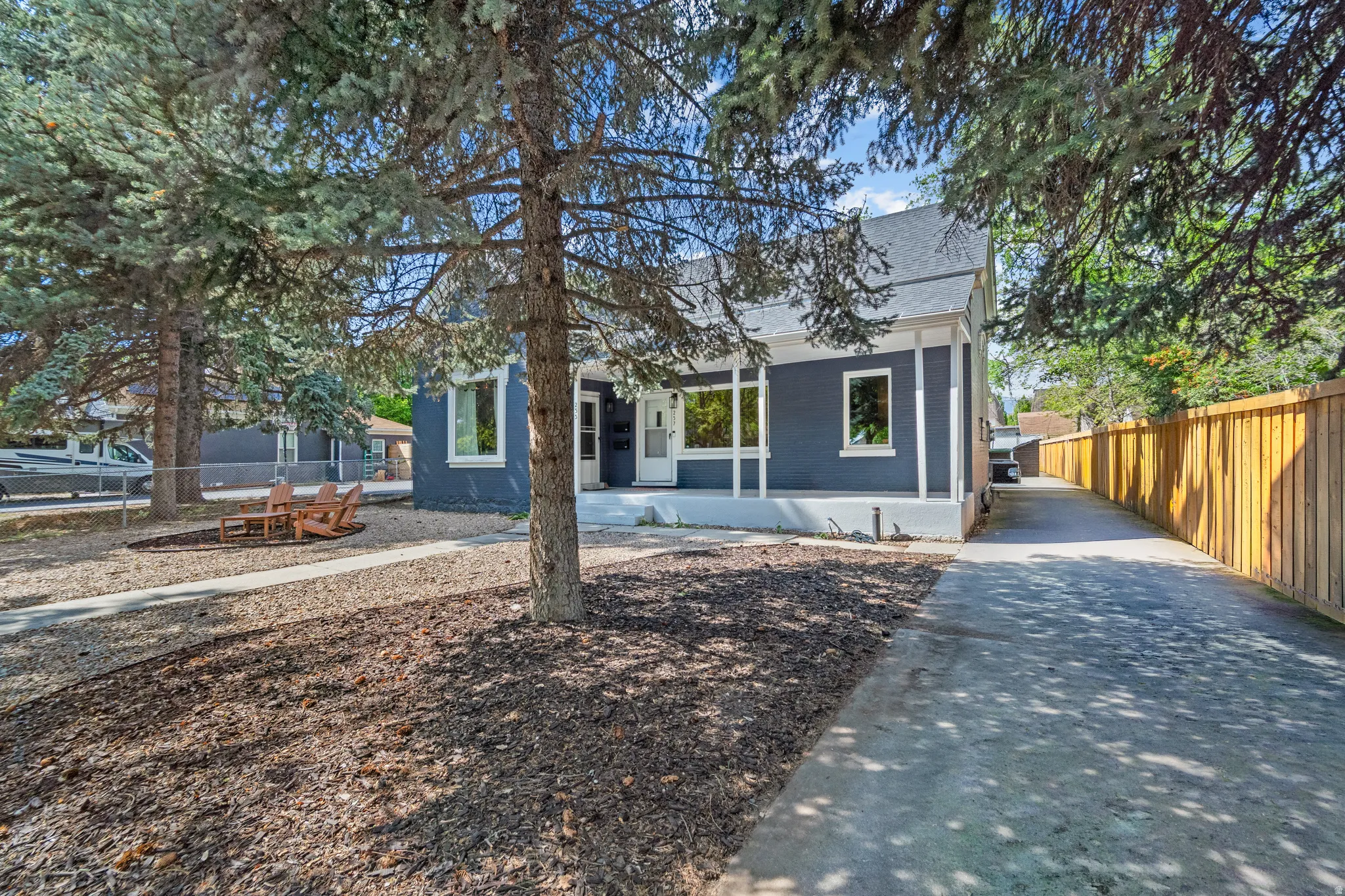 View of front of property featuring brick siding and a shingled roof