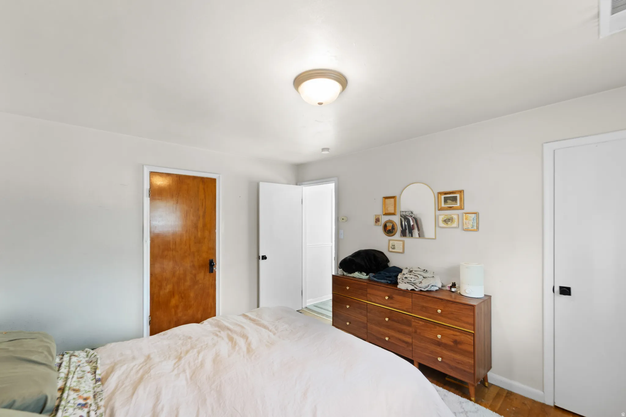 Bedroom featuring wood finished floors and baseboards
