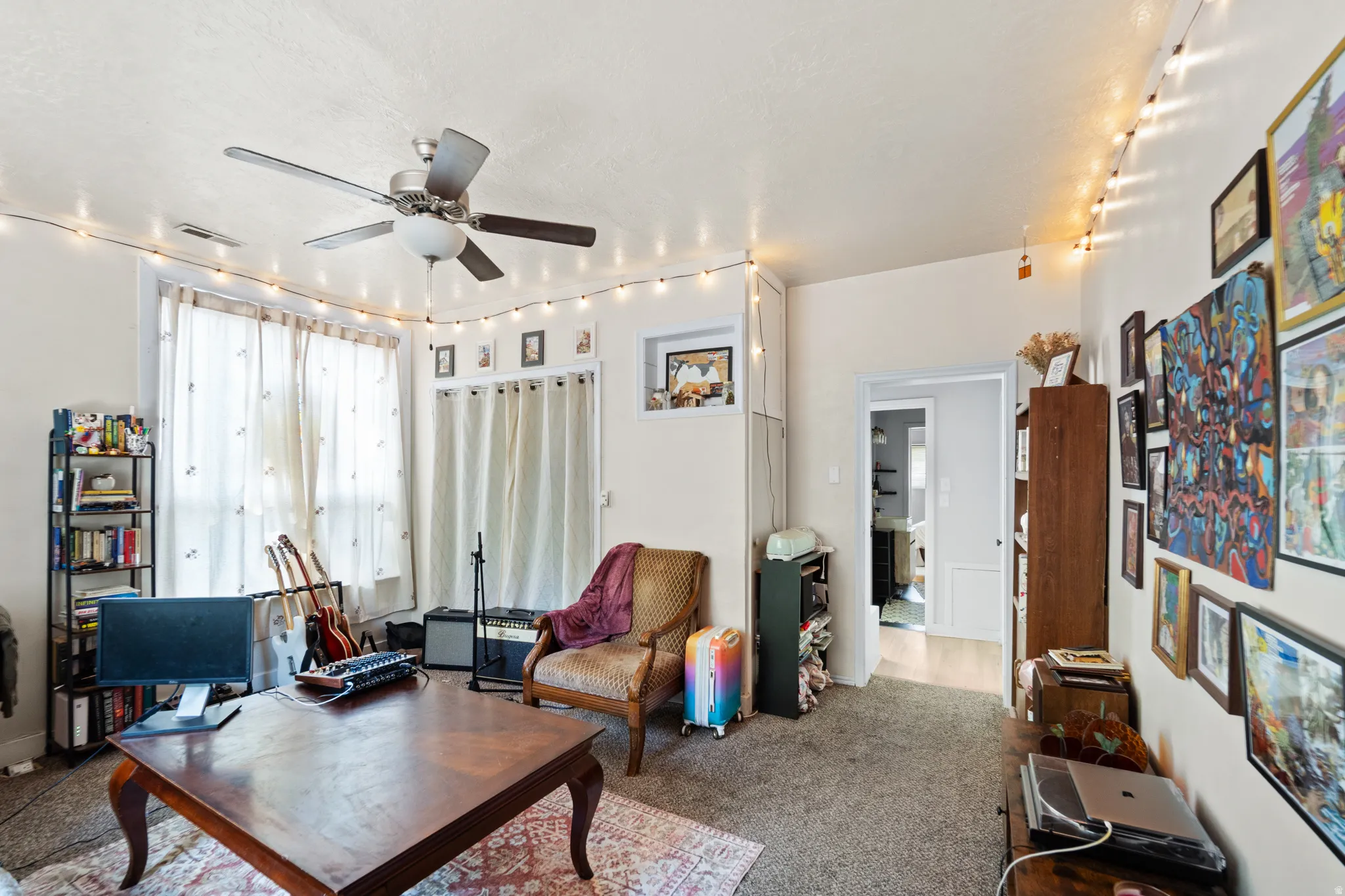 Living room with carpet floors and ceiling fan