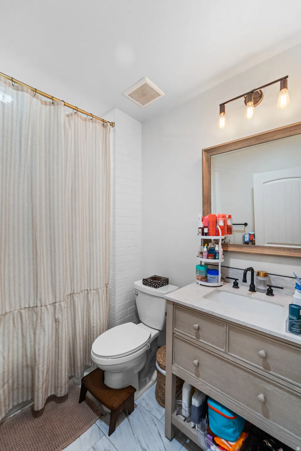 Full bath featuring vanity and a shower with curtain