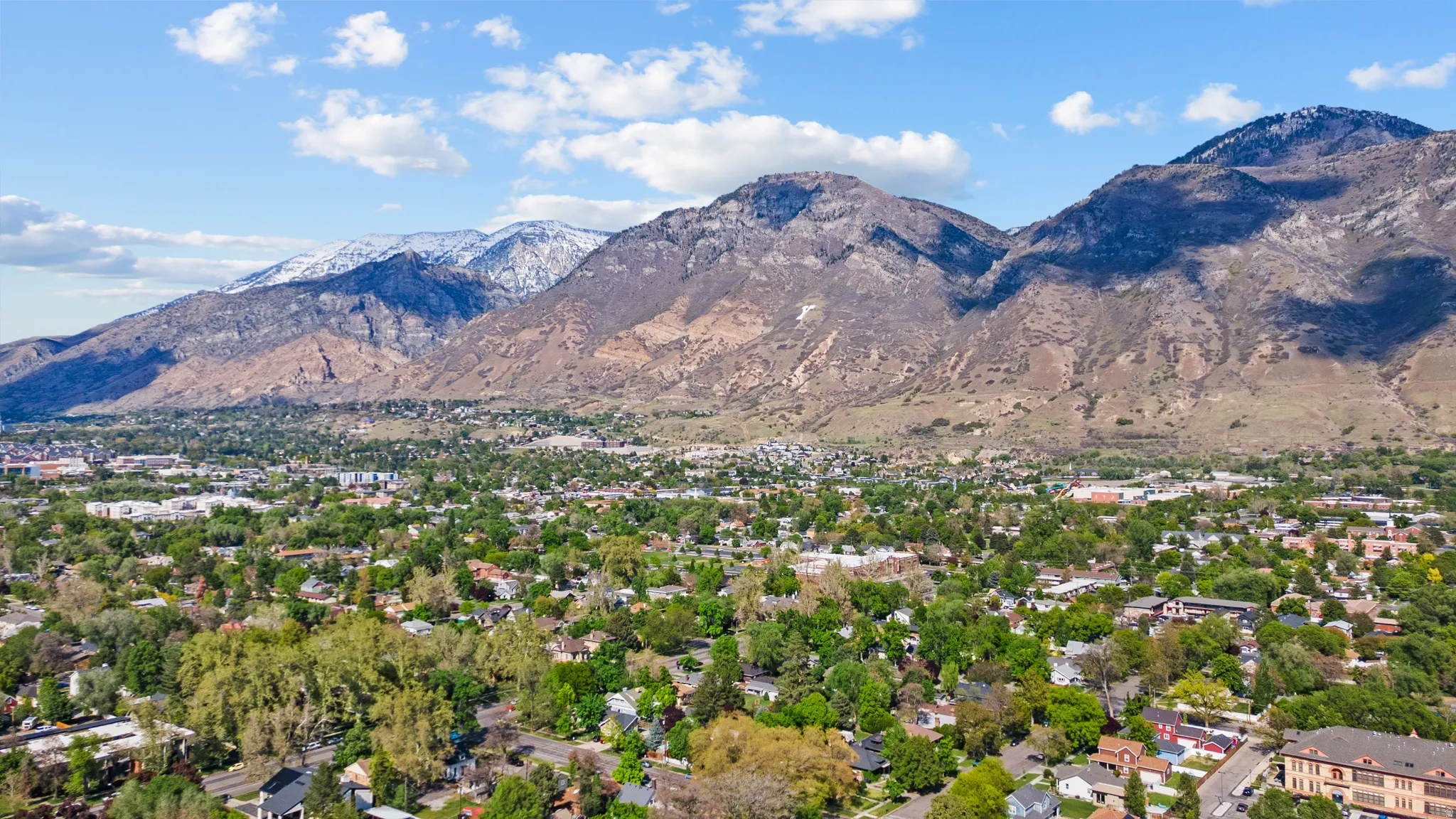 View of mountain backdrop featuring nearby suburban area