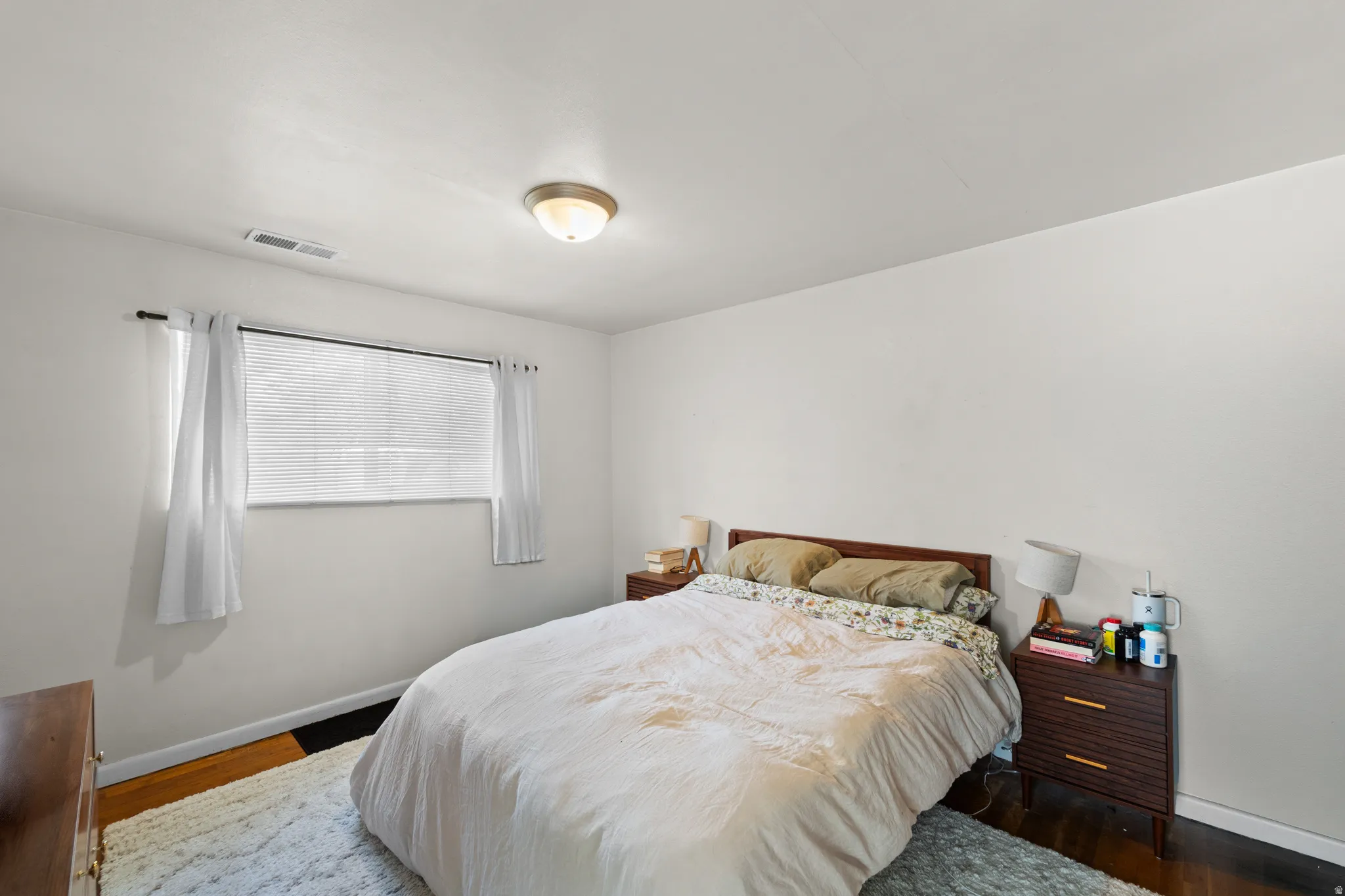 Bedroom featuring baseboards and wood finished floors