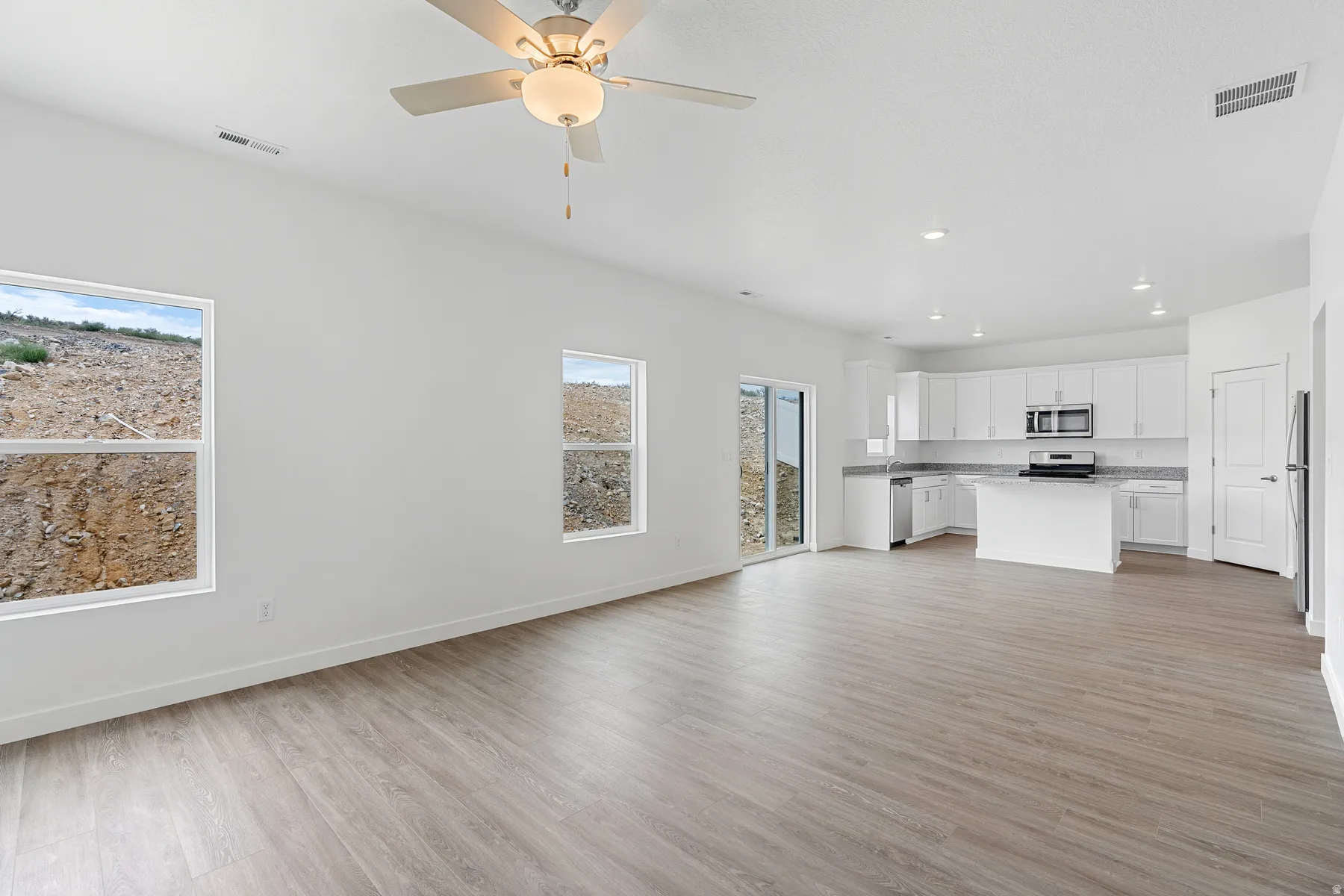 Unfurnished living room with a ceiling fan, light wood-style floors, and recessed lighting