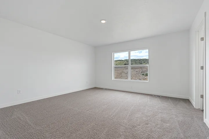 Spare room featuring baseboards and carpet floors