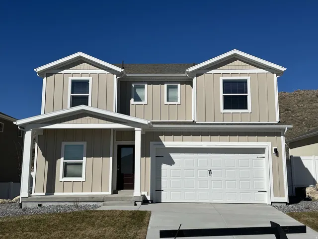 View of front of property with an attached garage and board and batten siding