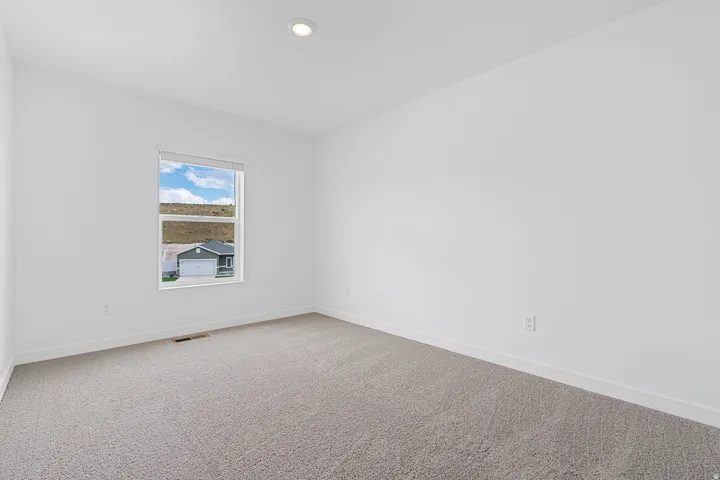 Unfurnished room featuring baseboards and light colored carpet