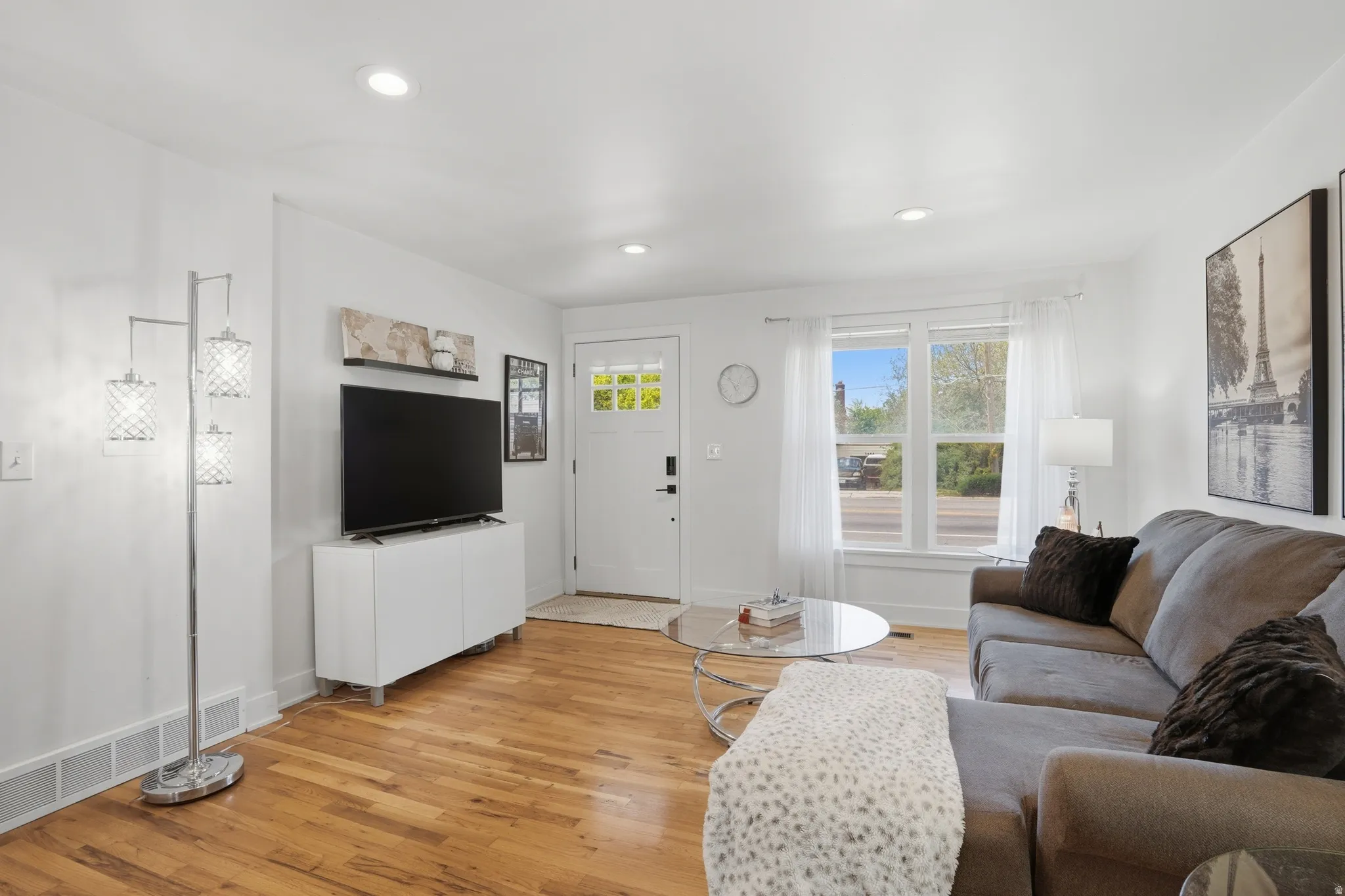 Living area featuring light wood finished floors and recessed lighting