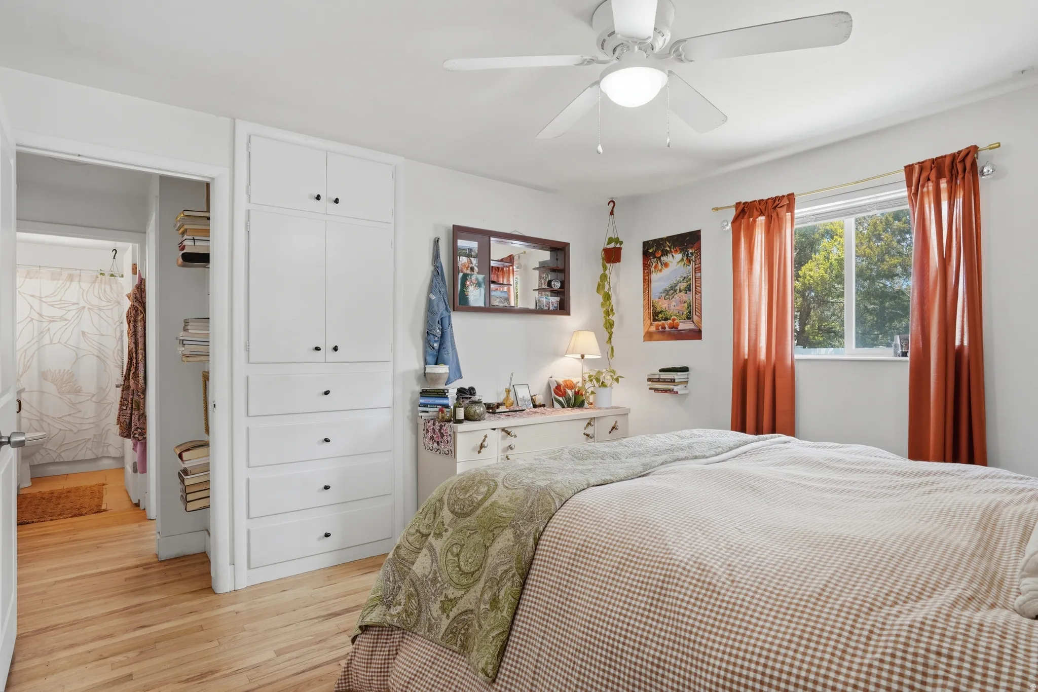 Bedroom with light wood-style floors, a ceiling fan, and a closet