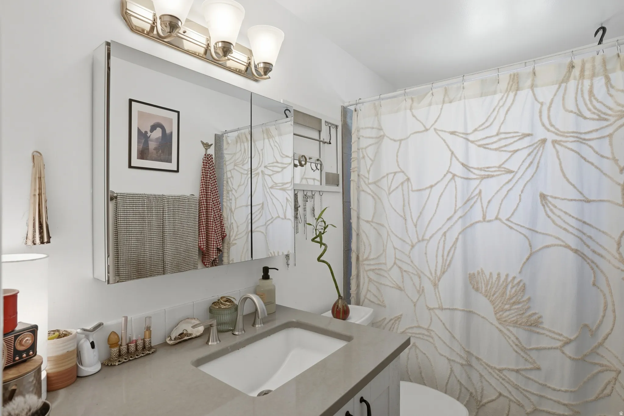 Full bathroom with vanity and curtained shower