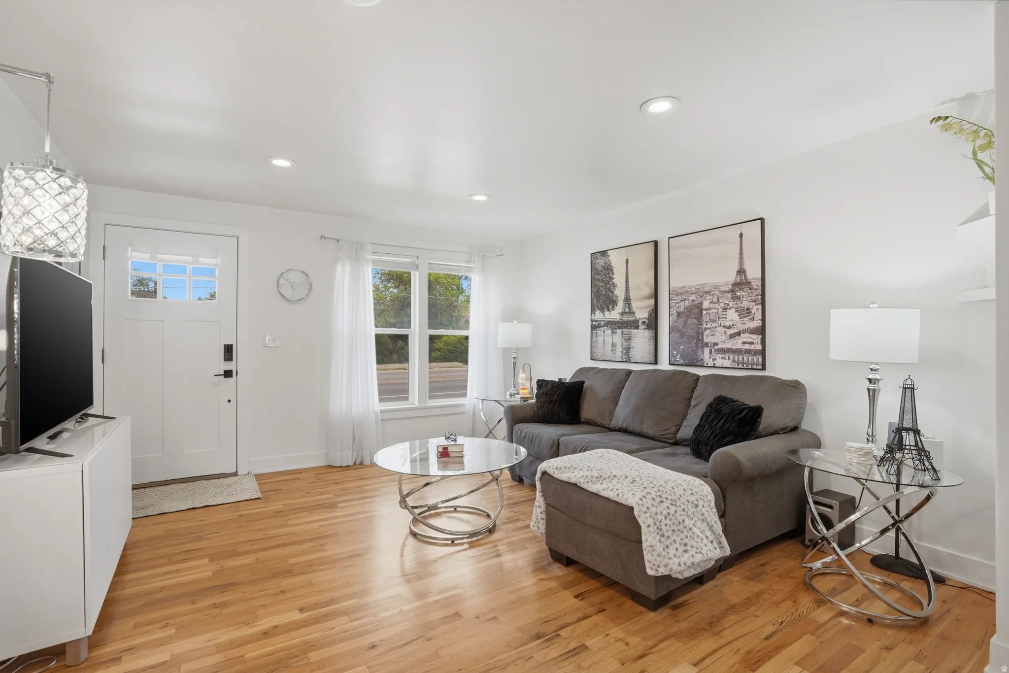 Living area featuring light wood finished floors and recessed lighting