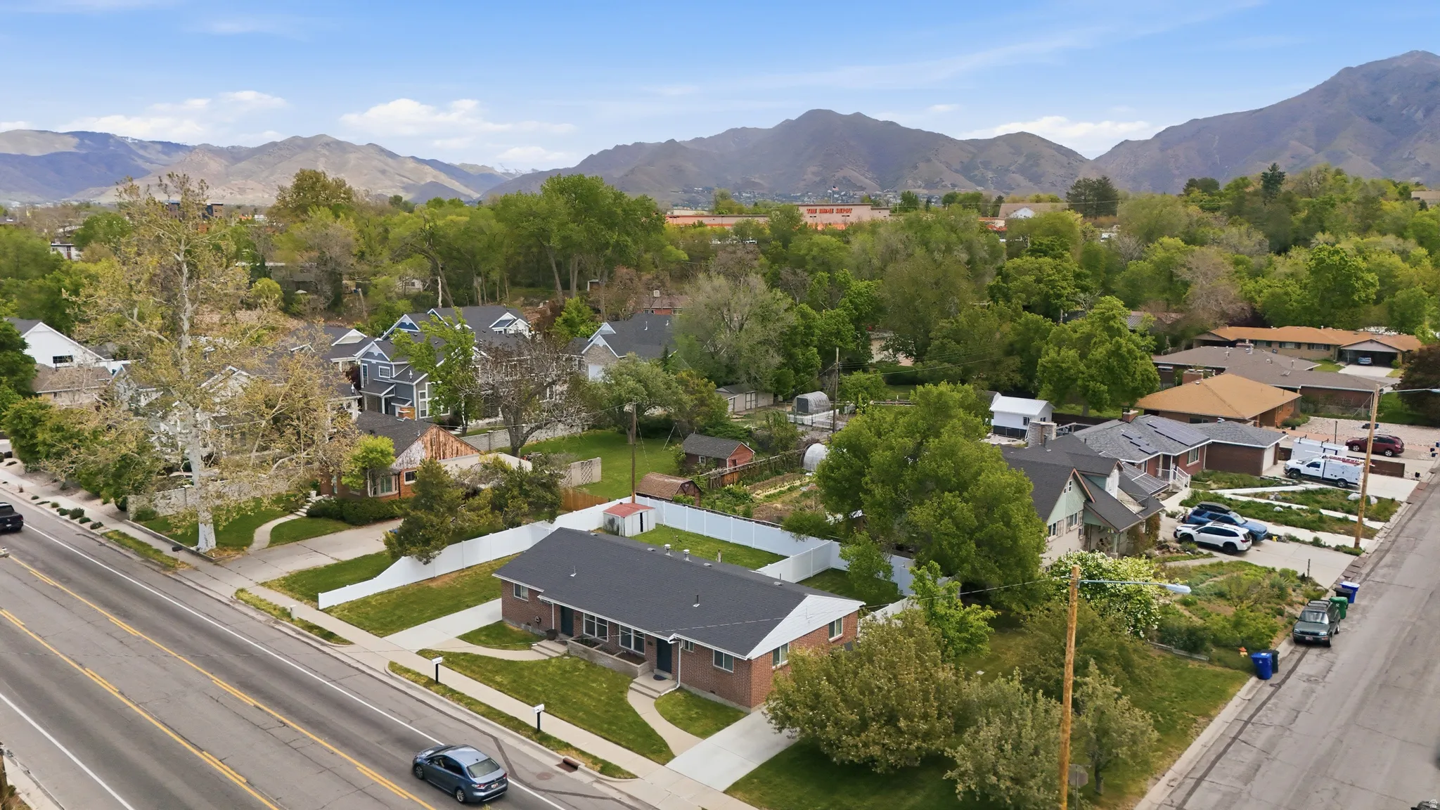 Aerial perspective of suburban area featuring a mountainous background