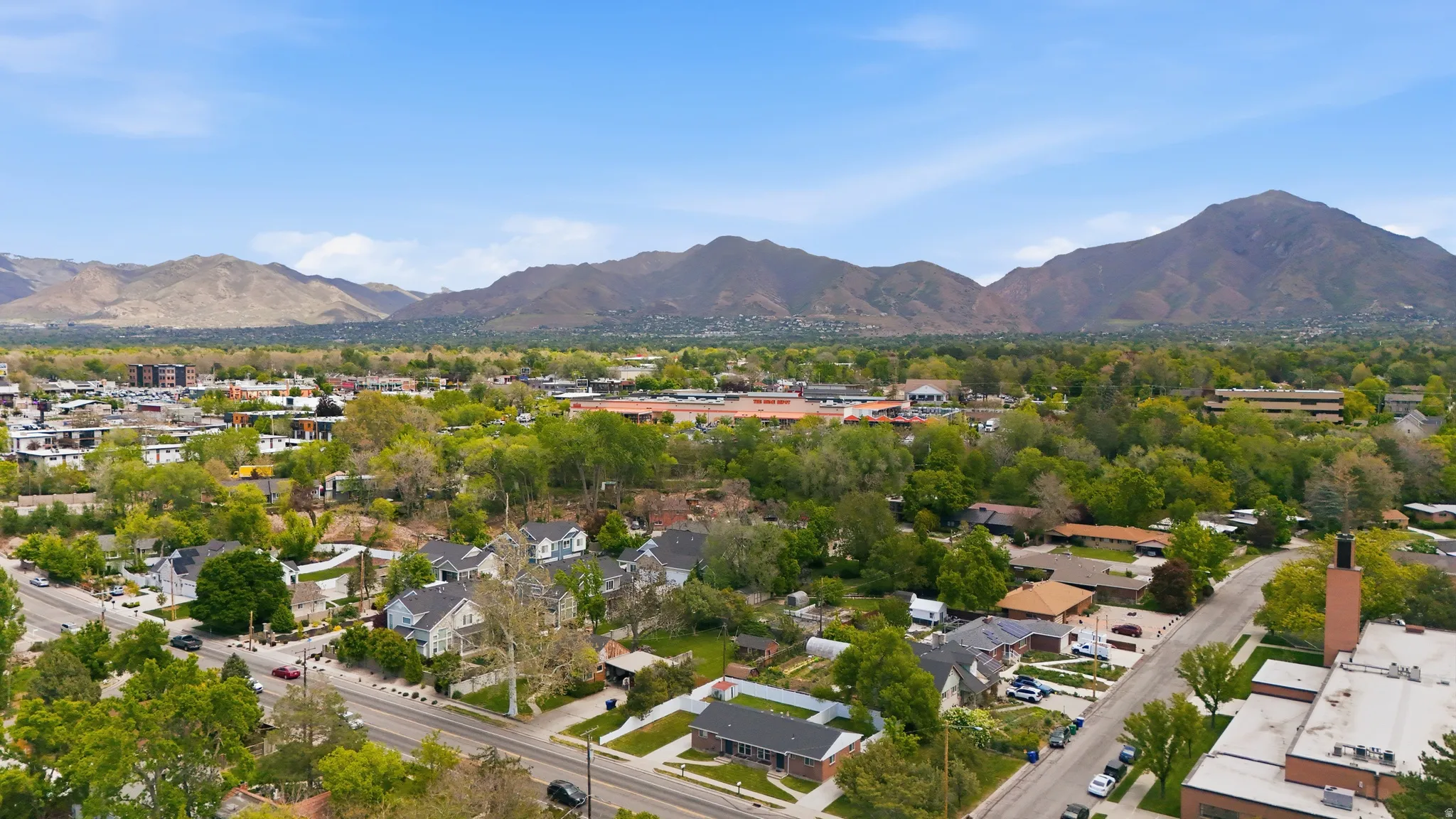 Aerial perspective of suburban area featuring a mountainous background