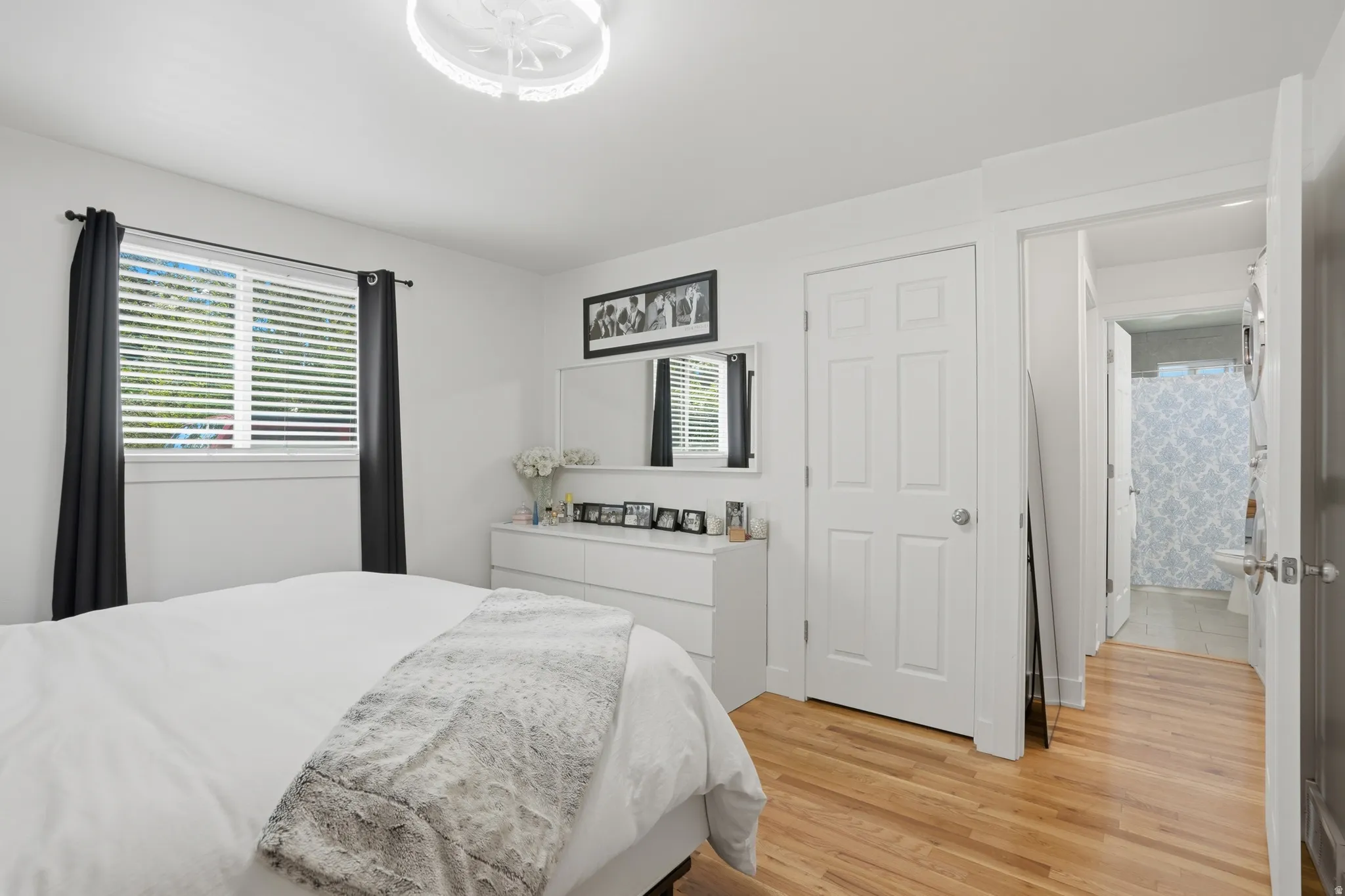 Bedroom with light wood-style floors and wallpapered walls