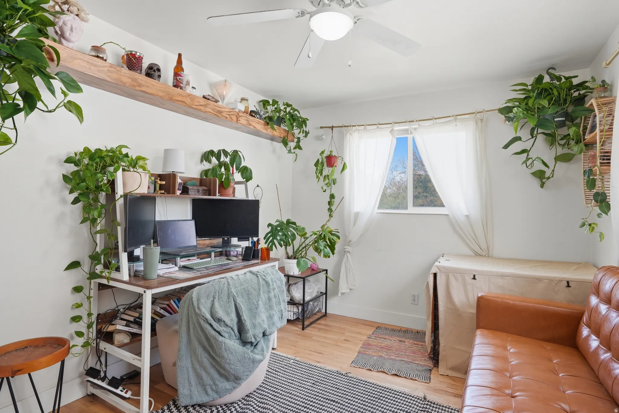 Office area with wood finished floors and ceiling fan