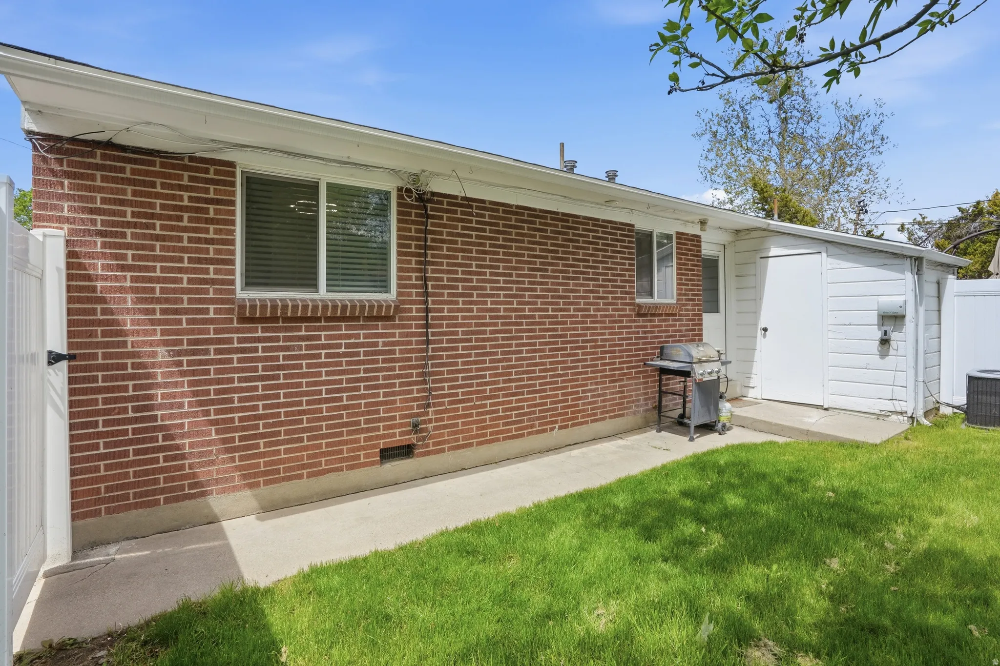 Rear view of property featuring brick siding