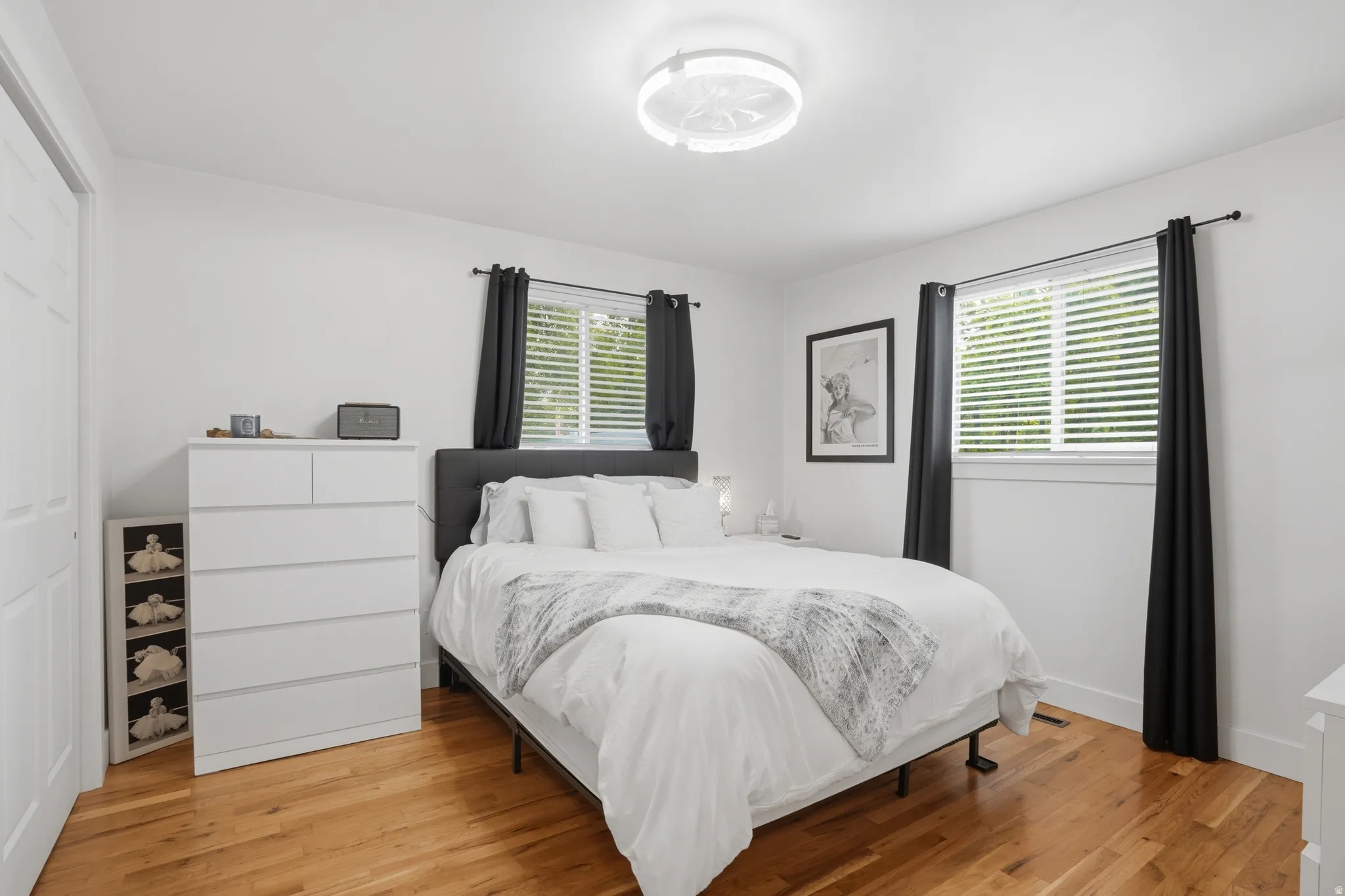Bedroom featuring light wood finished floors and a closet