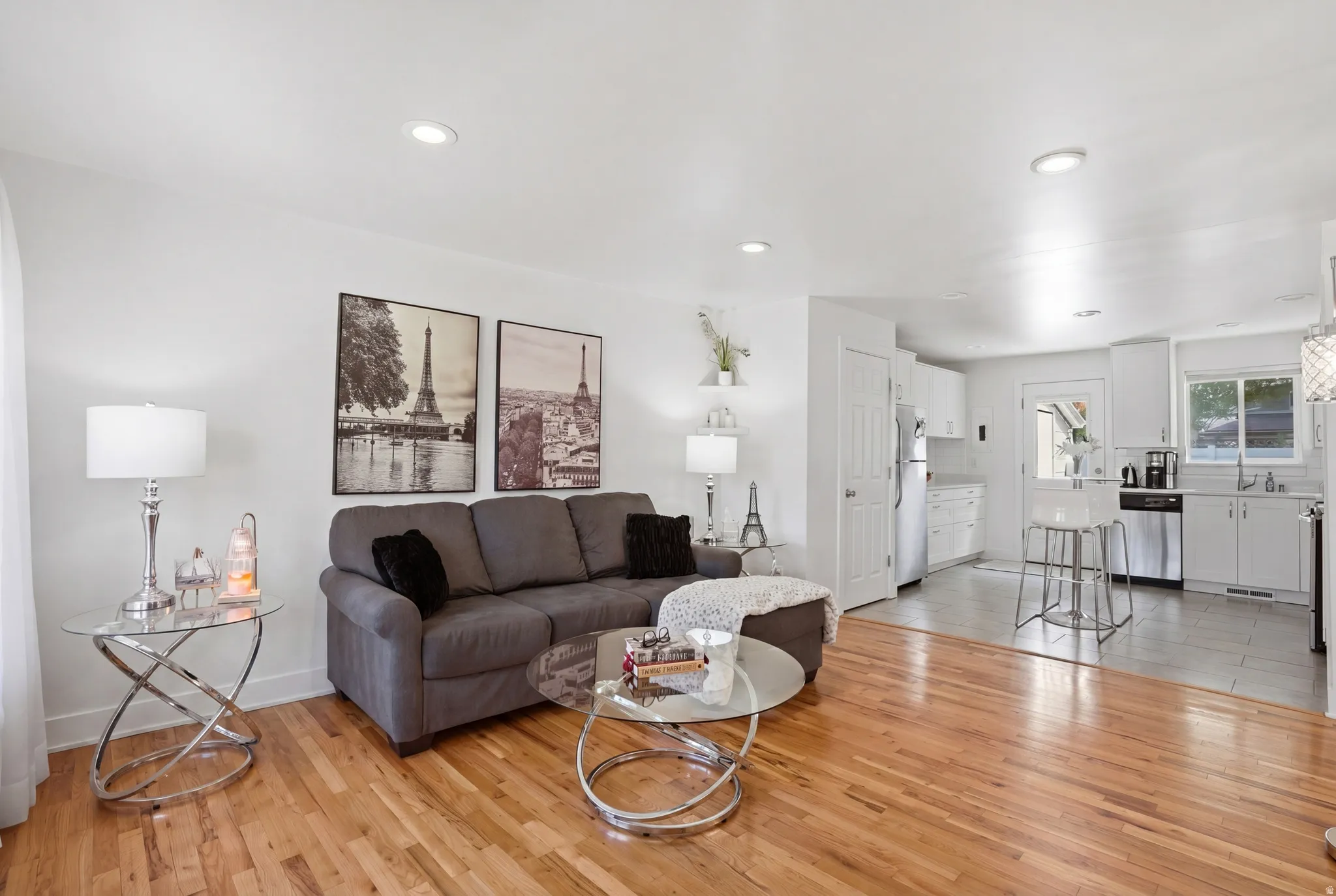 Living room with light wood-style floors and recessed lighting