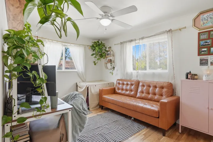 Living area featuring wood finished floors and ceiling fan