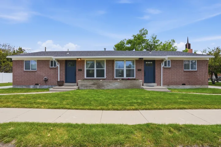 Ranch-style home featuring brick siding, a front yard, crawl space, and a chimney
