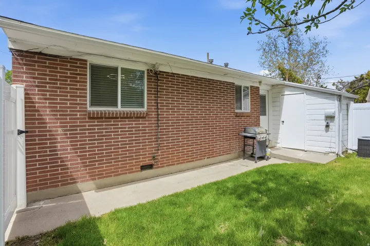 Rear view of property featuring brick siding